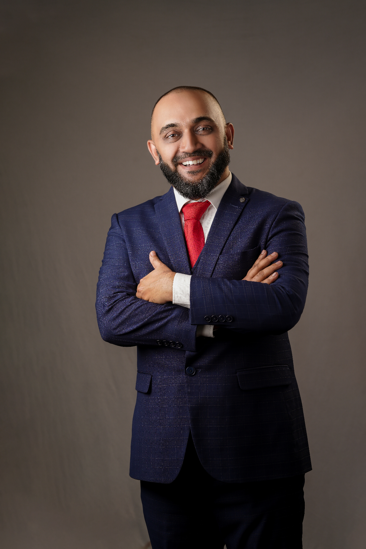 Rafeeq Cherusseri in a blue suit with folded arms